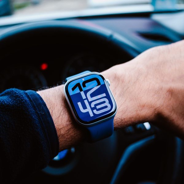 Modern smartwatch displaying 12:45 in a luxury car interior, highlighting tech-savvy and lifestyle themes.